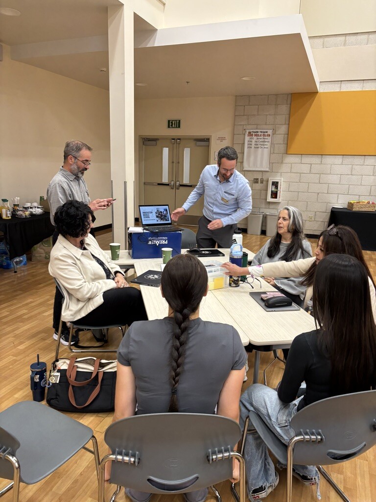 Educators and designers in a collaborative design session around a table